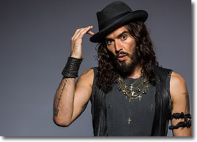 Russell Brand wearing a black hat